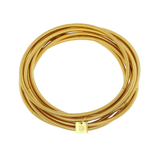 Set di sette bracciali rigidi ZAG Bijoux in acciaio dorato diametro 6 cm