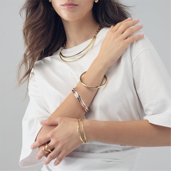 Bracciale rigido da donna Unoaerre in bronzo dorato liscio